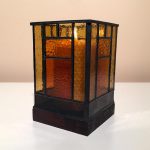 Three quarter view of stained-glass votive candle holder